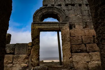 Zerzevan Kalesi taş kemerli tarihî kapısı ve Mezopotamya'nın taş mimarisini gösteren arkeolojik fotoğraf.
